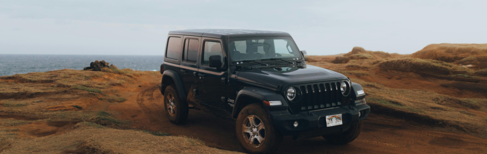 Off road Jeep vehicle by parked by the coast