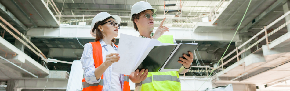 Construction managers pointing at a work site