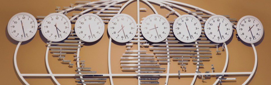 multiple analog clocks showing world times with a steel global map in the background