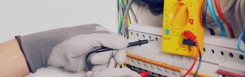 hands with gloves on inspecting a circuit breaker