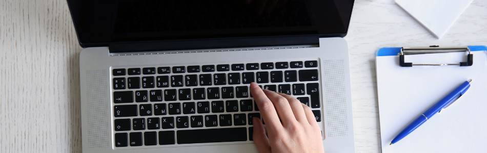Top view shot of hands typing on a laptop