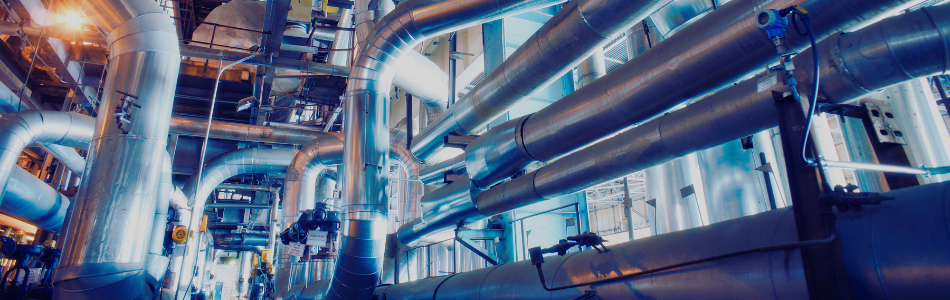 a labyrinth of steel piping in a factory setting